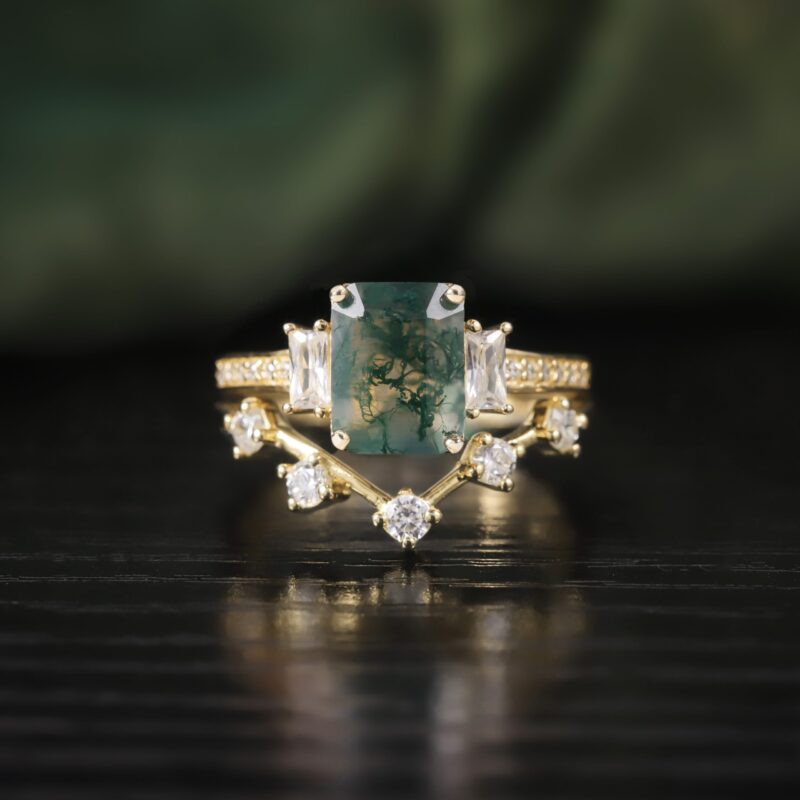 A framed painting of the forest with Emerald-Cut Moss Agate Ring Set in 18K gold plated over 925 sterling silver